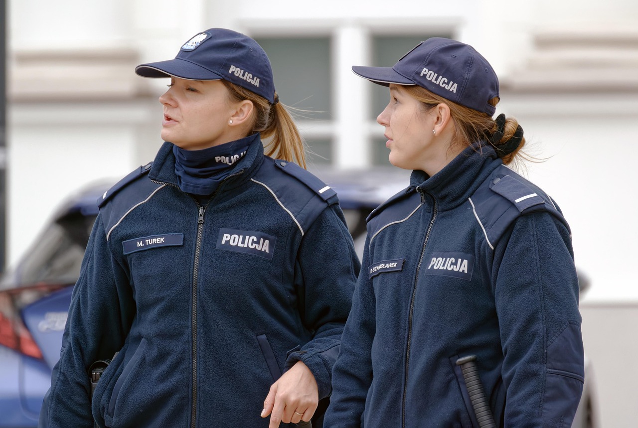 Vigile urbano in uniforme mentre controlla il traffico in una strada cittadina.
